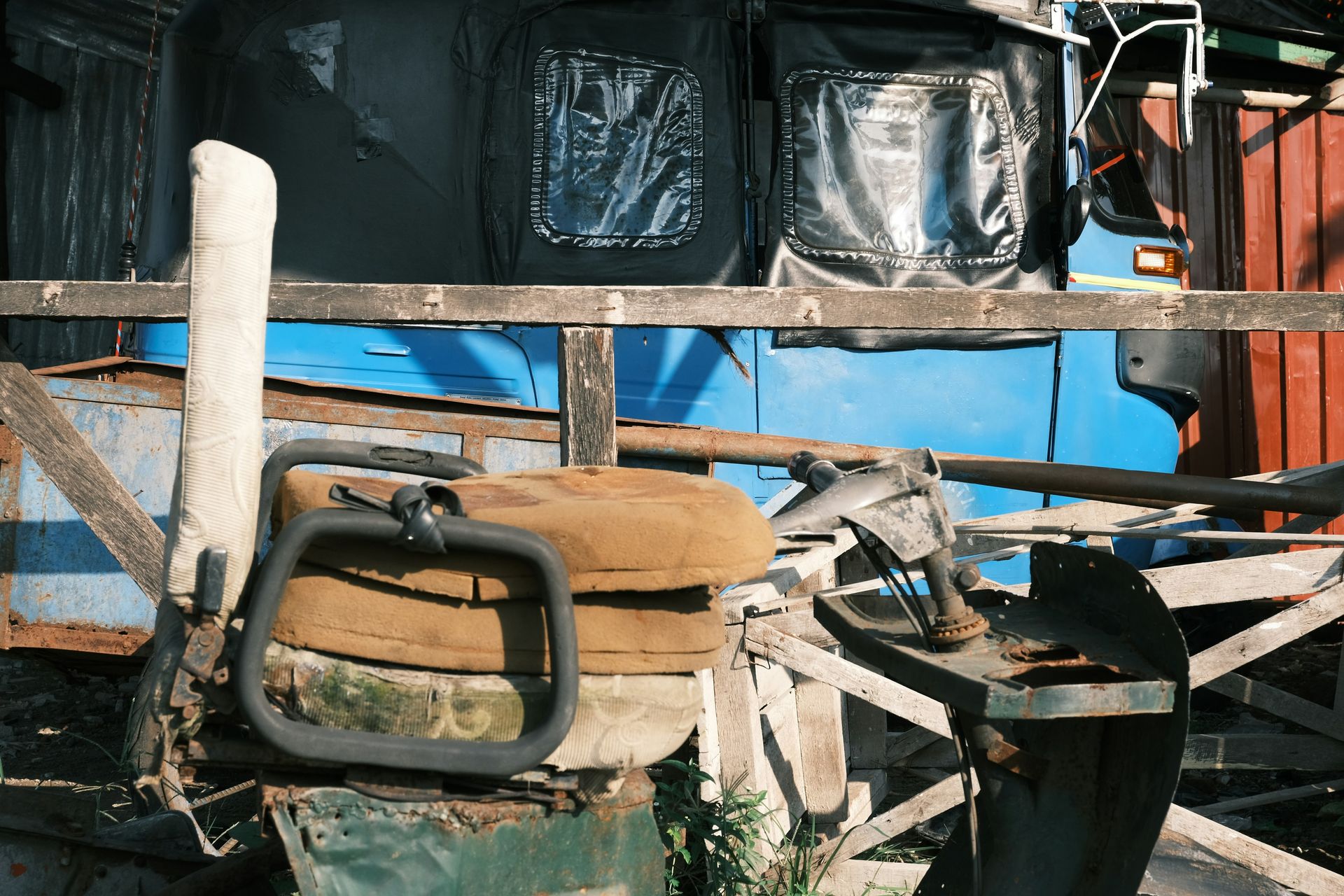 a pile of junk sitting next to a blue train