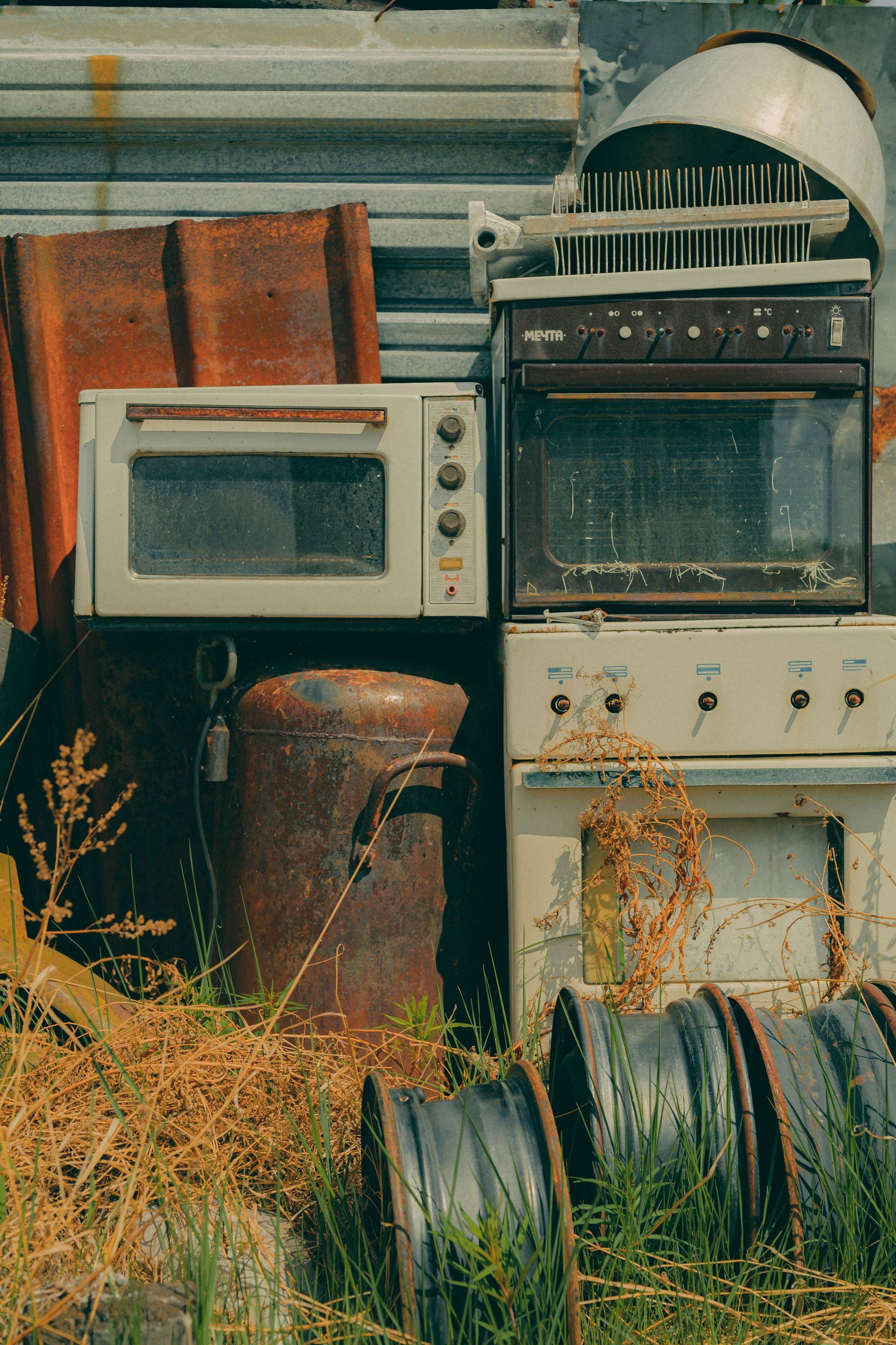 Old appliances and other items sit discarded.